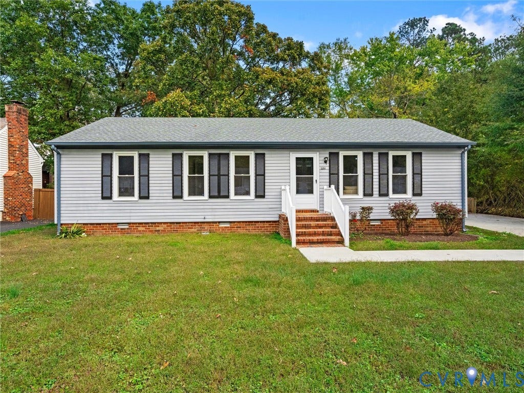 5504 Chanson Road, Salem Woods, North Chesterfield, VA 23237 Ranch-style exterior featuring light-toned vinyl siding, dark shutters, a brick foundation, a central brick chimney, and a white-railed entrance