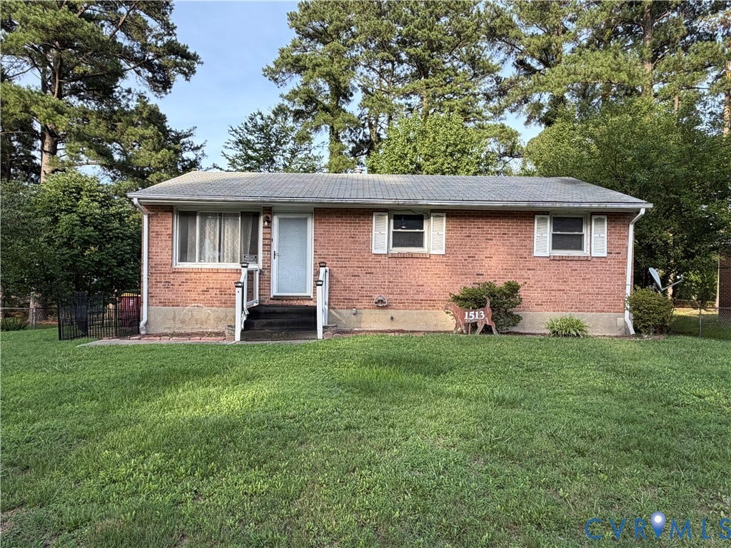 1513 West Lane, Petersburg, VA 23803 Ranch-style residence featuring a brick facade, asphalt shingle roof, white window shutters, and a front entrance with a metal railing