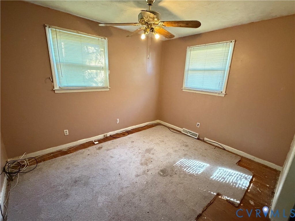 1513 West Lane, Petersburg, VA 23803 Room featuring two windows, neutral-toned walls, and a ceiling-mounted light fixture with a fan