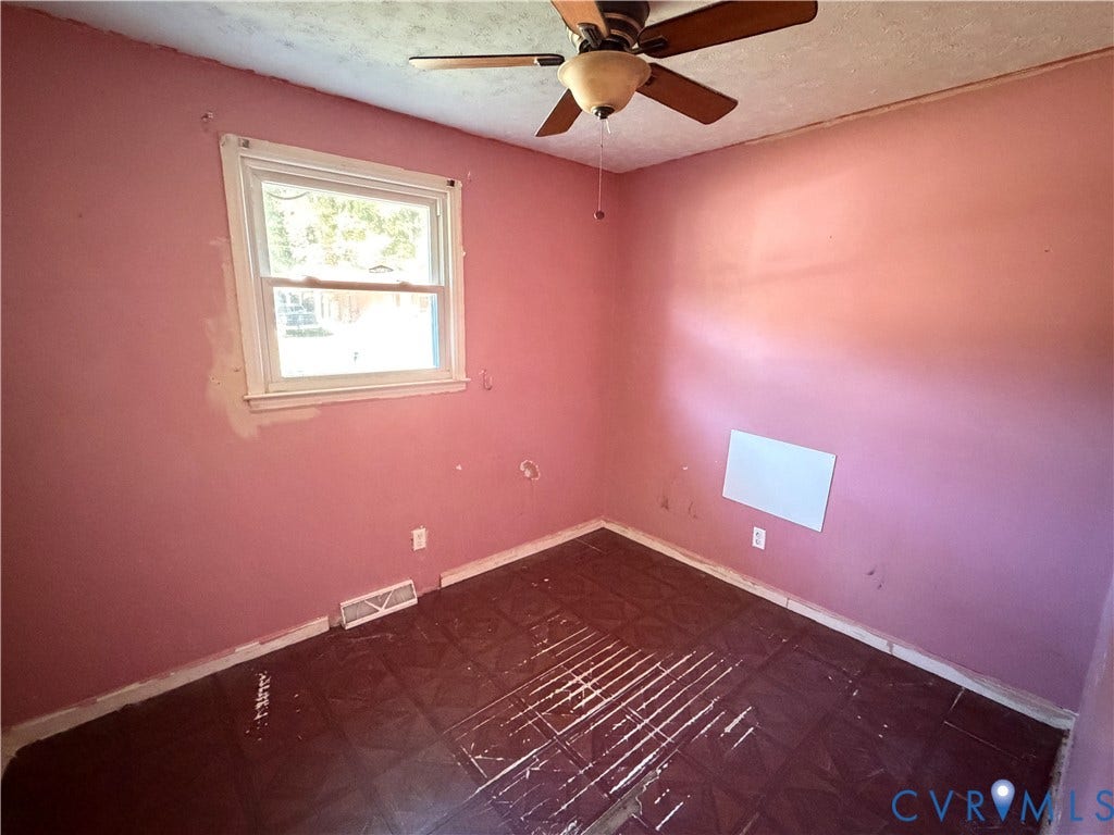 1513 West Lane, Petersburg, VA 23803 Room featuring dark square tile flooring, a single-hung window, and a ceiling-mounted fan with integrated lighting