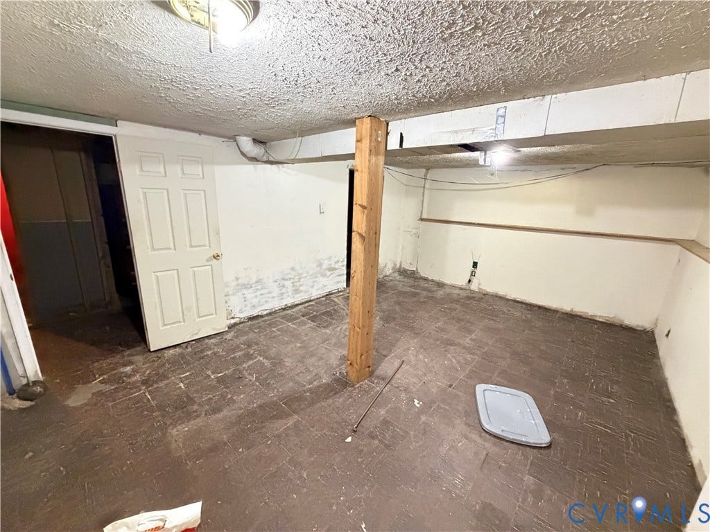 1513 West Lane, Petersburg, VA 23803 Interior space featuring tile flooring, exposed structural wood post, and a paneled interior door