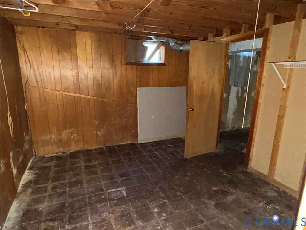 1513 West Lane, Petersburg, VA 23803 Interior space featuring wood paneling, tile flooring, a window, and a door