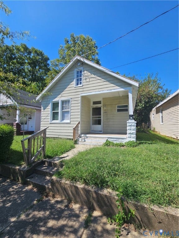 3503 Lawson Street, Richmond, VA 23224 Single-story residence featuring horizontal siding, a covered front porch, a stone-finished support column, and a gable roofline