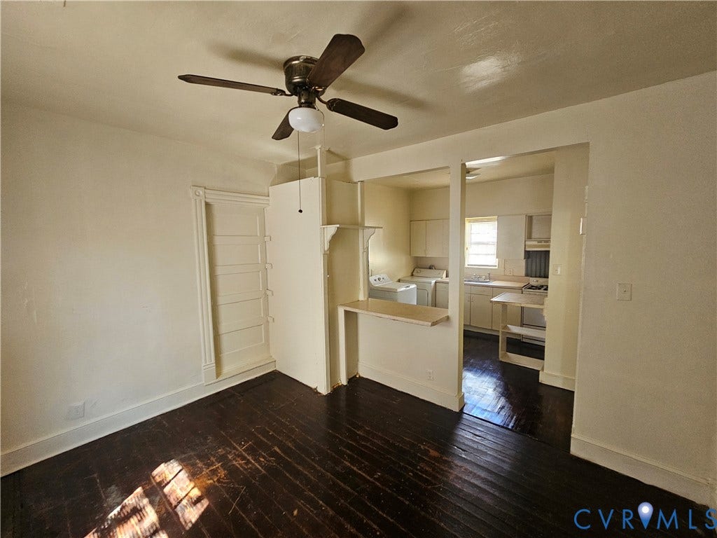3503 Lawson Street, Richmond, VA 23224 Dark-toned wood-finish flooring, central ceiling fan with integrated light fixture, built-in shelving, and a peninsula counter separating the kitchen area