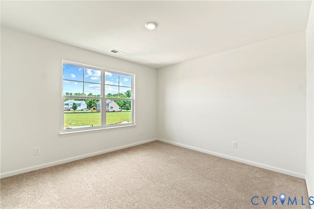 11231 Chappell Creek Circle, Chappell Creek, North Prince George, VA 23860 Bright interior space featuring a multi-pane window, neutral carpet, and white walls
