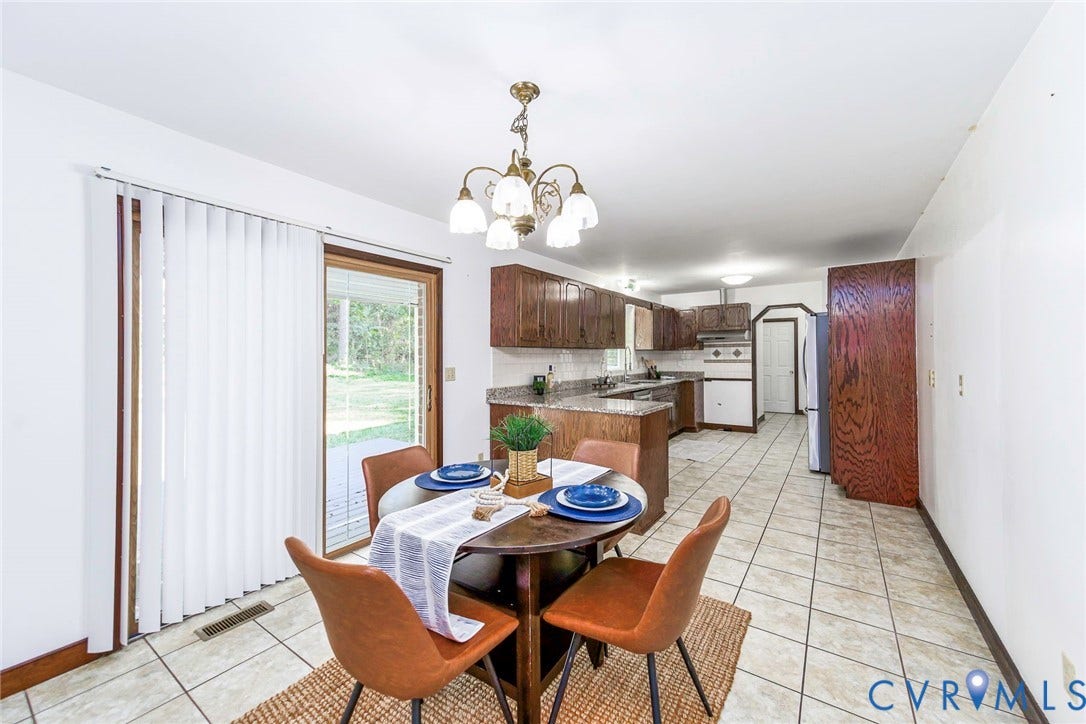 4124 Cogbill Road, Ampthill, VA 23234 Kitchen featuring wood cabinetry, stone-finish countertops, ceramic tile flooring, a multi-bulb chandelier, and a sliding glass door
