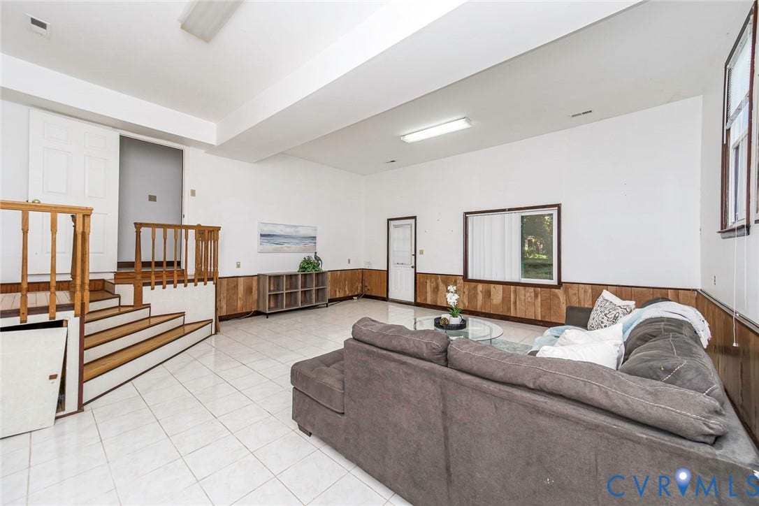 4124 Cogbill Road, Ampthill, VA 23234 Tile flooring, wood-panel wall wainscoting, and a wooden staircase featuring a spindle railing
