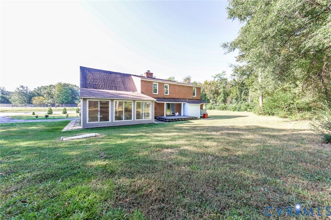 4124 Cogbill Road, Ampthill, VA 23234 Exterior featuring a brick and siding facade, multi-pane sunroom, and wood deck