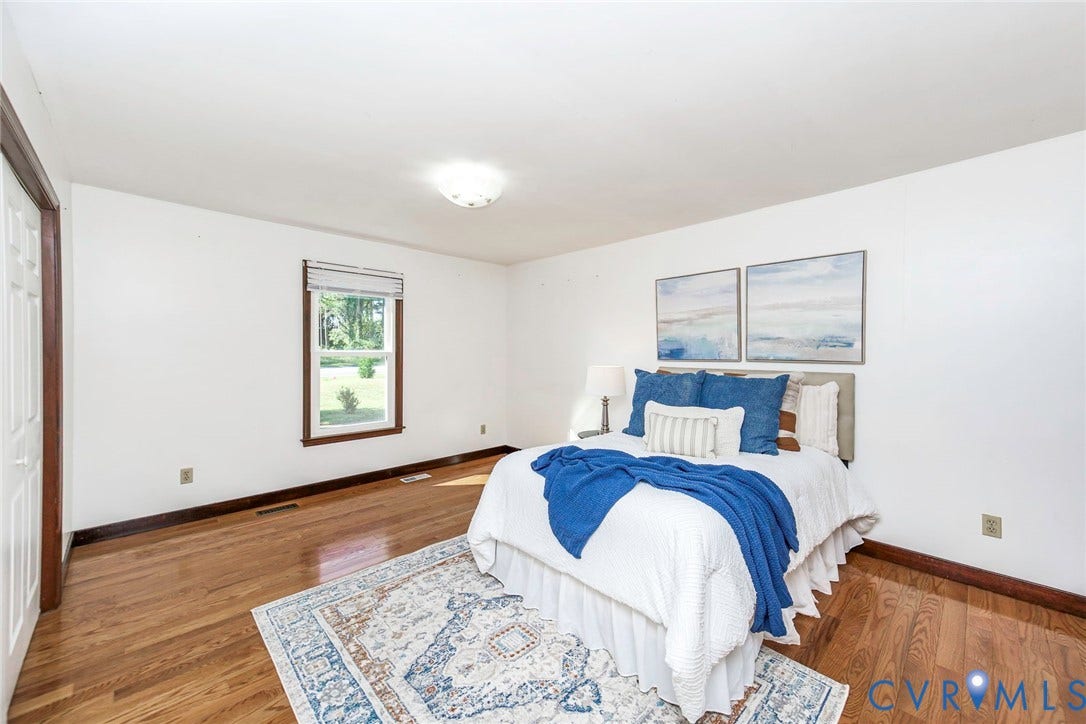 4124 Cogbill Road, Ampthill, VA 23234 Spacious room featuring wood-finish flooring, neutral wall paint, and a double-pane window with wood trim