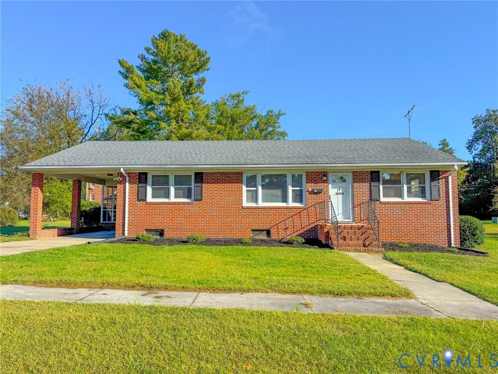 109 Rock Castle Avenue, Crewe, VA 23930 Brick exterior, attached carport, asphalt shingle roof, multi-pane windows, and concrete front walkway