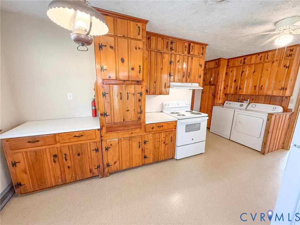 109 Rock Castle Avenue, Crewe, VA 23930 Custom knotty wood cabinetry featuring hardware with a dark finish, solid surface countertops, white freestanding range, and ceiling-mounted light fixtures