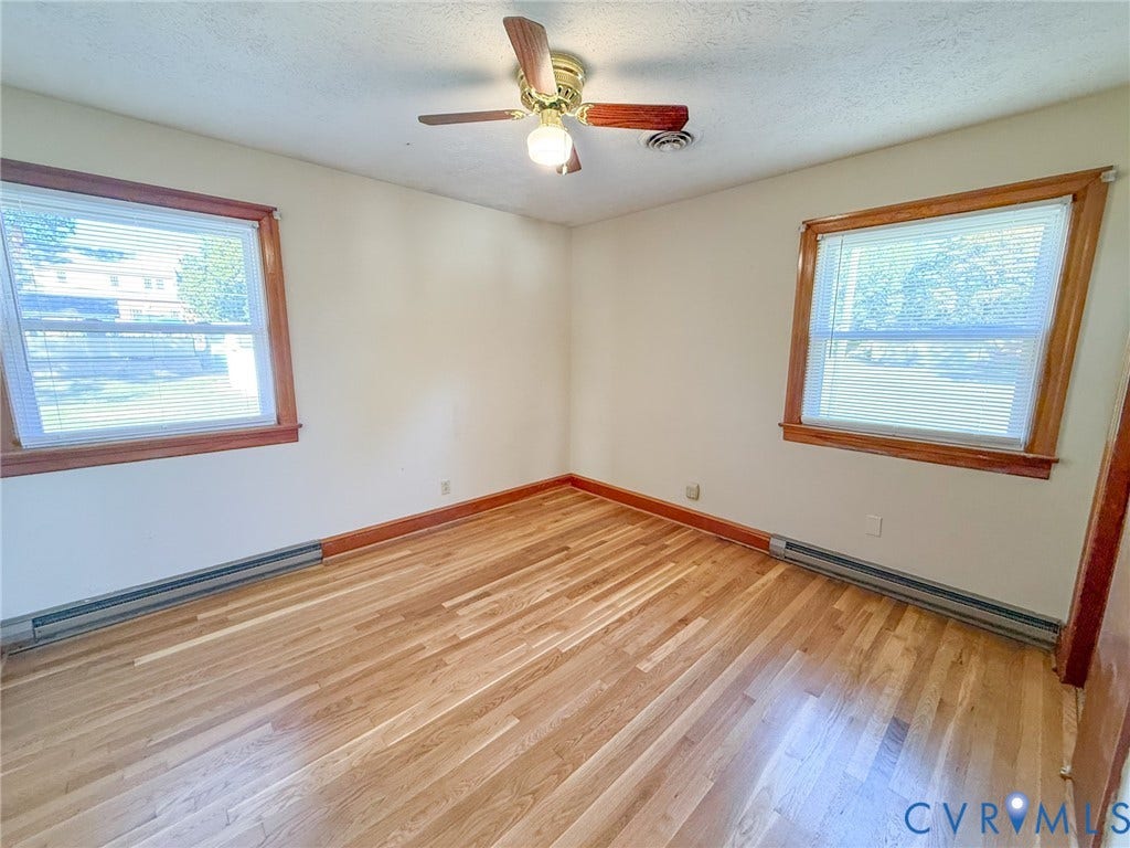 109 Rock Castle Avenue, Crewe, VA 23930 Wood-finish flooring, dual windows with wood trim, and a ceiling-mounted fan with light fixture