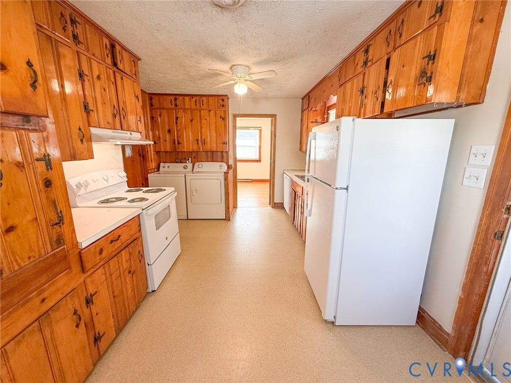 109 Rock Castle Avenue, Crewe, VA 23930 Kitchen featuring extensive wood-finish cabinetry, white built-in appliances, and a ceiling-mounted fan