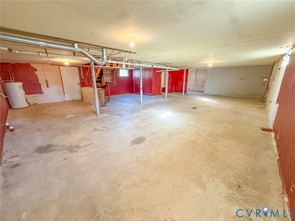 109 Rock Castle Avenue, Crewe, VA 23930 Unfinished basement featuring concrete flooring, masonry block walls, metal support columns, and an exposed water heater