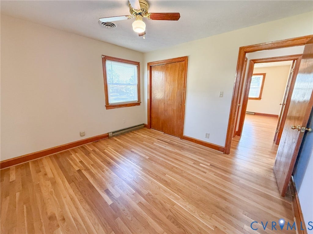 109 Rock Castle Avenue, Crewe, VA 23930 Wood-finish flooring, double-door wood closet, ceiling fan with integrated lighting, and natural wood trim surrounding the door and window frame
