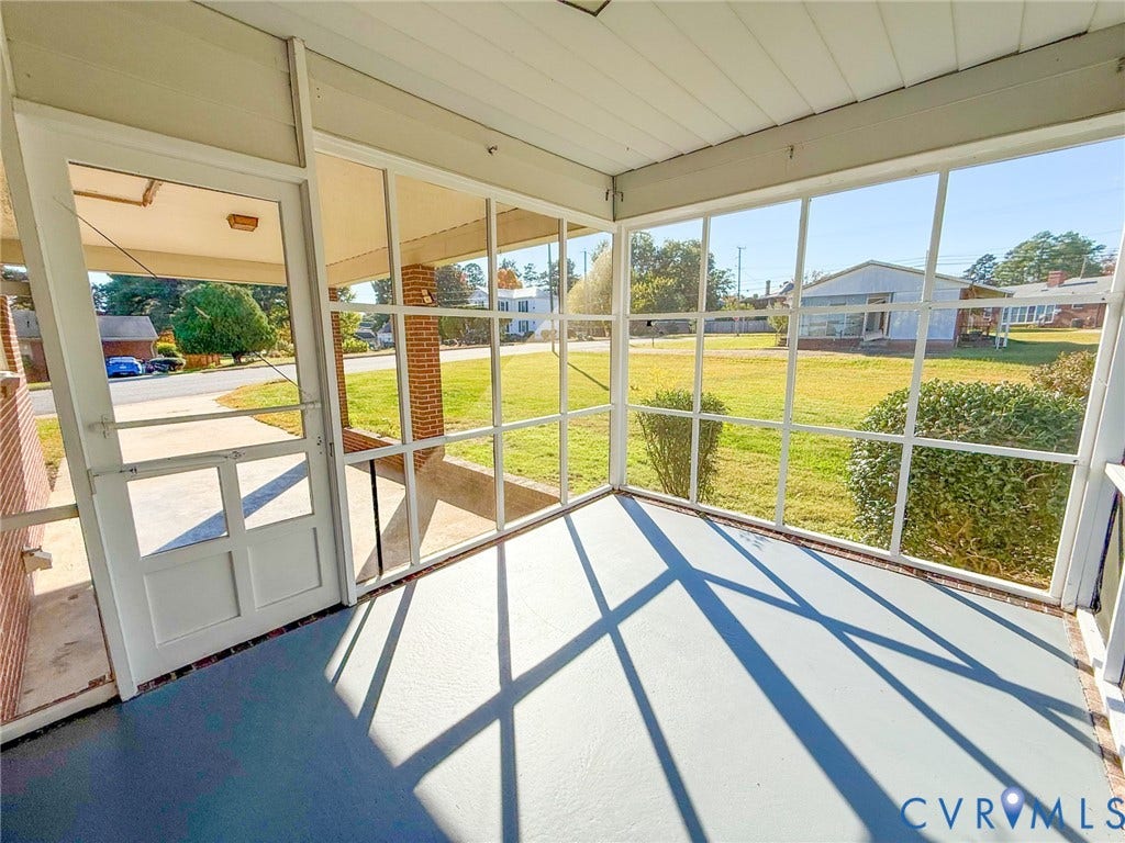 109 Rock Castle Avenue, Crewe, VA 23930 Screened-in porch featuring a painted concrete floor, white-frame full-height screening, and exposed brick column detailing