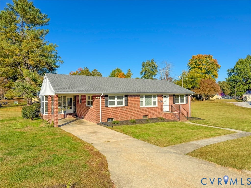 109 Rock Castle Avenue, Crewe, VA 23930 Single-story brick exterior featuring a shingle roof, attached covered porch, concrete driveway, and white-trimmed windows