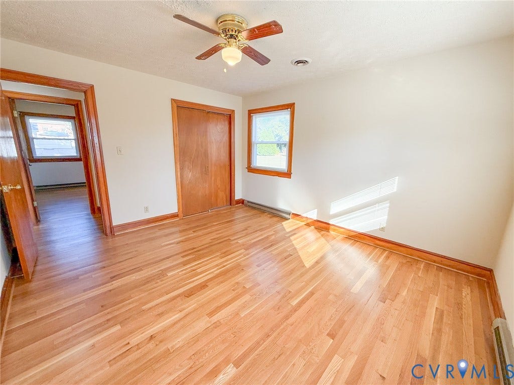 109 Rock Castle Avenue, Crewe, VA 23930 Room featuring wood-finish flooring, wood-trim window casings, wood-door closet, and ceiling fan with integrated light fixture