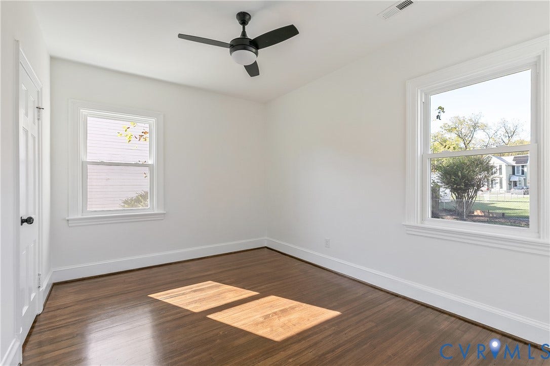 24 N Elm Avenue, Henrico, VA 23075 Room featuring wood-finish flooring, dual windows, and a matte black ceiling fan