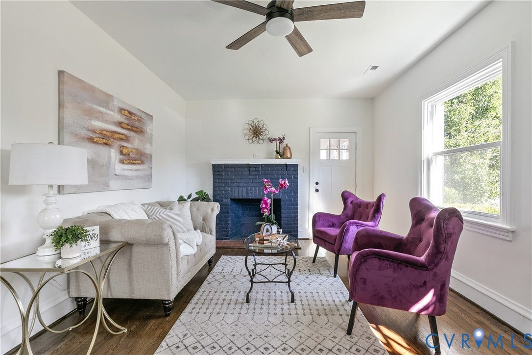 24 N Elm Avenue, Henrico, VA 23075 Painted brick fireplace, wood-finish flooring, ceiling fan with integrated lighting, and multi-pane window