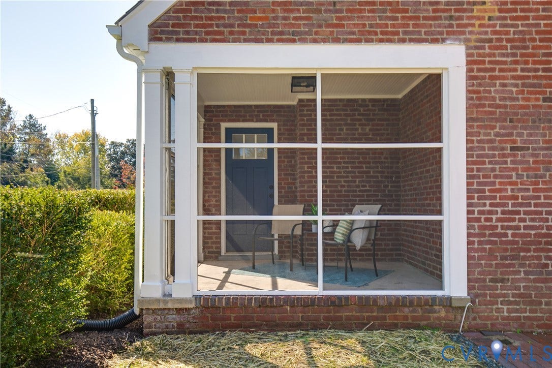 24 N Elm Avenue, Henrico, VA 23075 Screened porch featuring brick exterior walls, a concrete floor, beadboard ceiling, and a paneled entry door