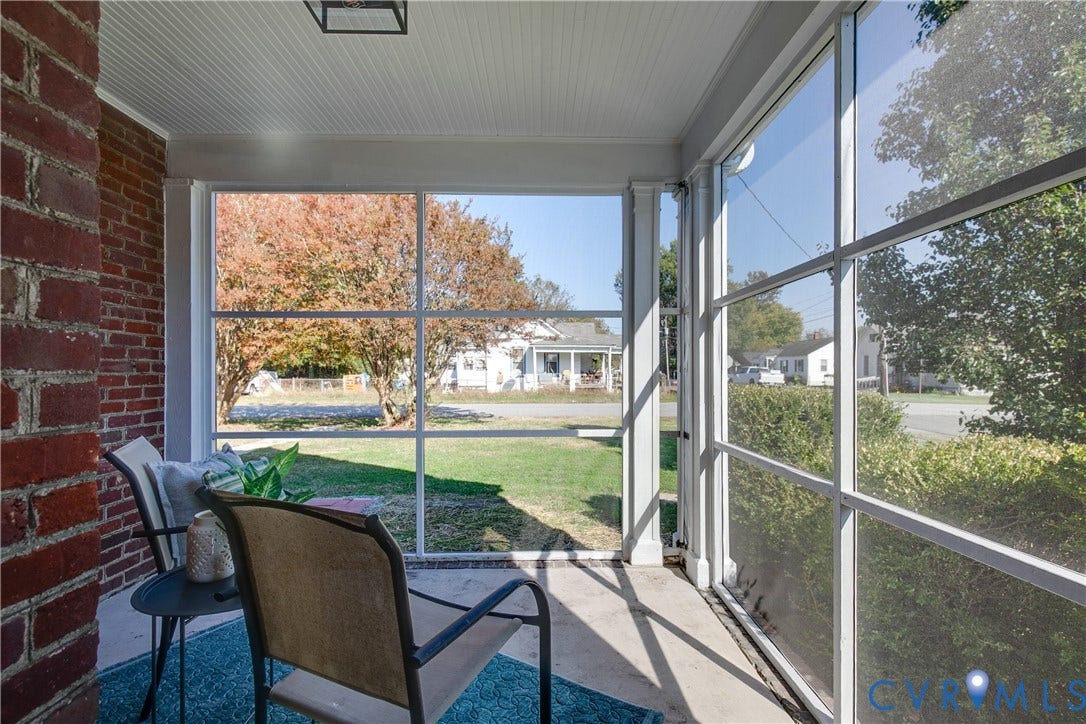24 N Elm Avenue, Henrico, VA 23075 Screened-in porch featuring a concrete floor, beadboard ceiling, brick accent wall, and white structural columns