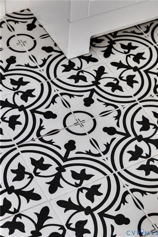 24 N Elm Avenue, Henrico, VA 23075 Decorative black and white patterned tile flooring featuring a high-contrast geometric floral motif and a solid white built-in cabinetry base