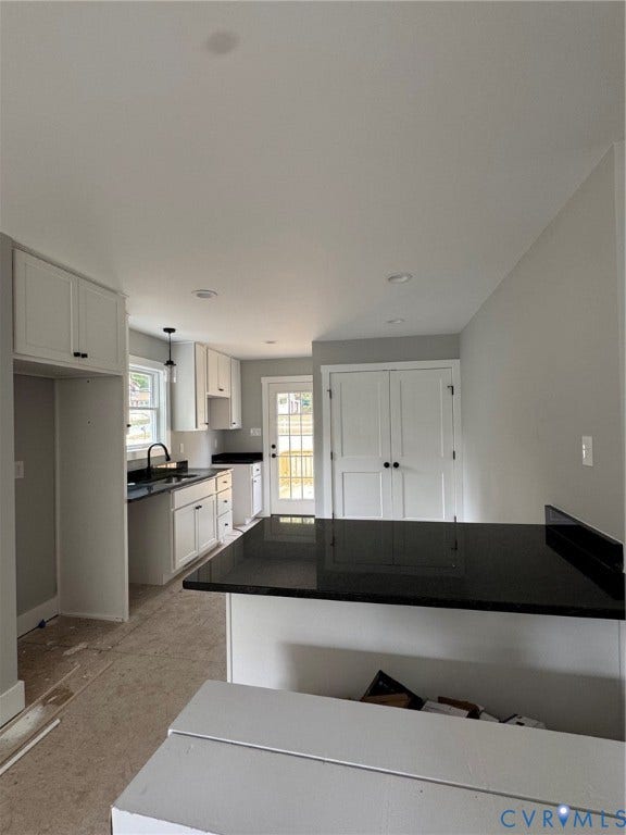 6012 Lakeside Drive, Woodhaven Shores, Quinton, VA 23141 Kitchen featuring white shaker-style cabinetry, dark stone-finish countertops, a breakfast bar, recessed lighting, and a glass-paneled exterior door