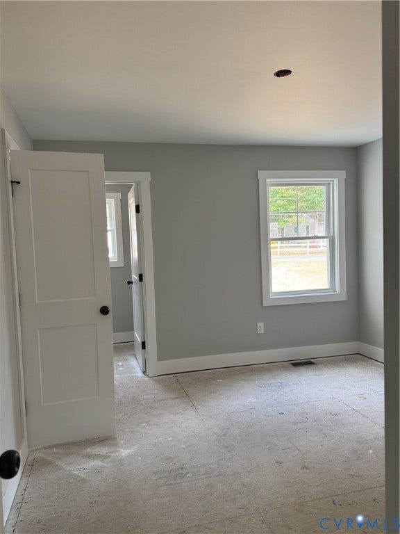 6012 Lakeside Drive, Woodhaven Shores, Quinton, VA 23141 Neutral-toned interior walls, white-painted door frames and window casings, two-panel interior door, and single-hung window with muntins