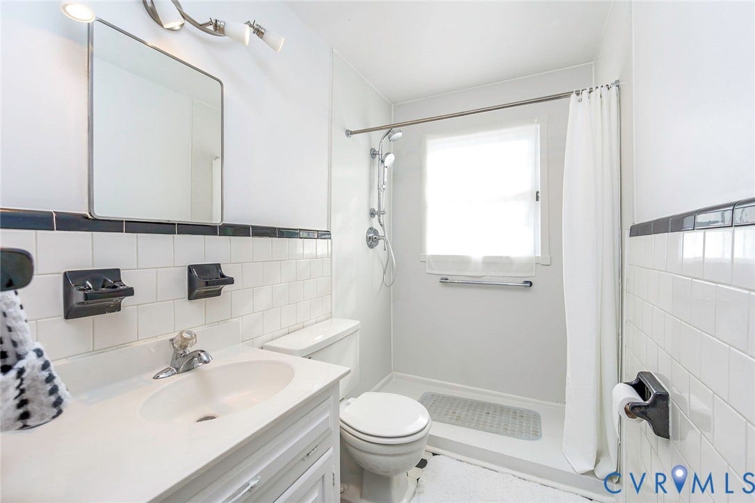 700 Lakeside Drive, Emporia, Emporia, VA 23847 Bathroom featuring white subway tile wall accents, a vanity with a white countertop and integrated sink, a walk-in shower with a handheld fixture, and a wall-mounted medicine cabinet