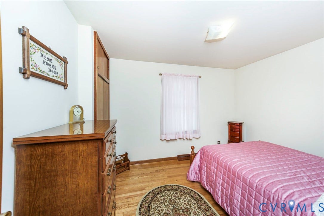 700 Lakeside Drive, Emporia, Emporia, VA 23847 Room featuring wood-finish flooring, a built-in floor-to-ceiling storage closet, and a square-pane window with a curtain rod