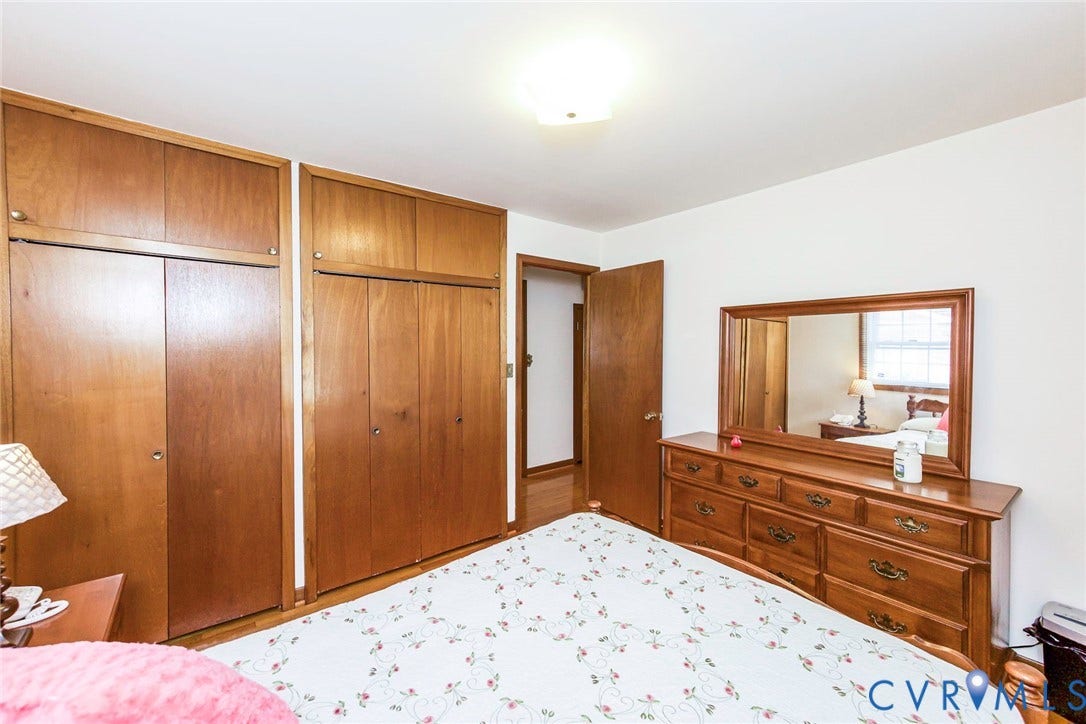 700 Lakeside Drive, Emporia, Emporia, VA 23847 Floor-to-ceiling wooden built-in cabinetry with overhead storage, wood-finish flooring, and a flush-mount ceiling light fixture