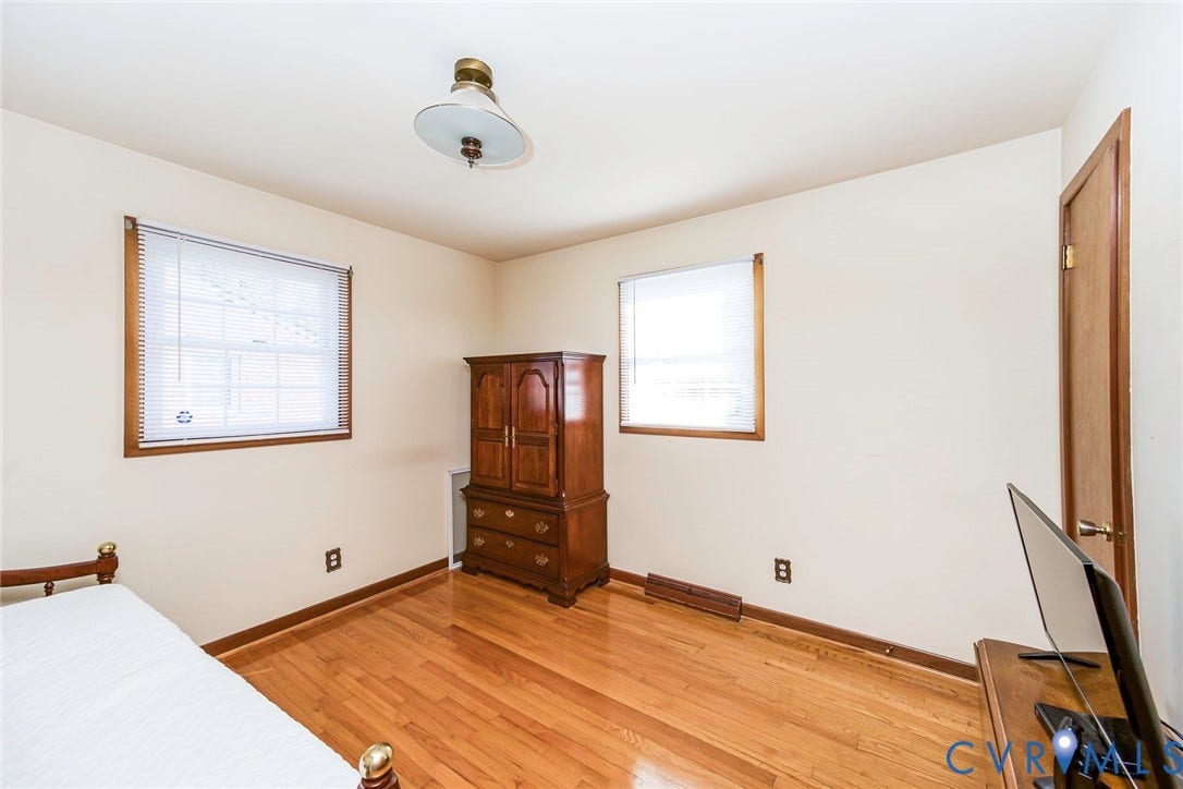 700 Lakeside Drive, Emporia, Emporia, VA 23847 Room featuring wood-finish flooring, two windows with wood-framed trim, and a centered flush-mount light fixture
