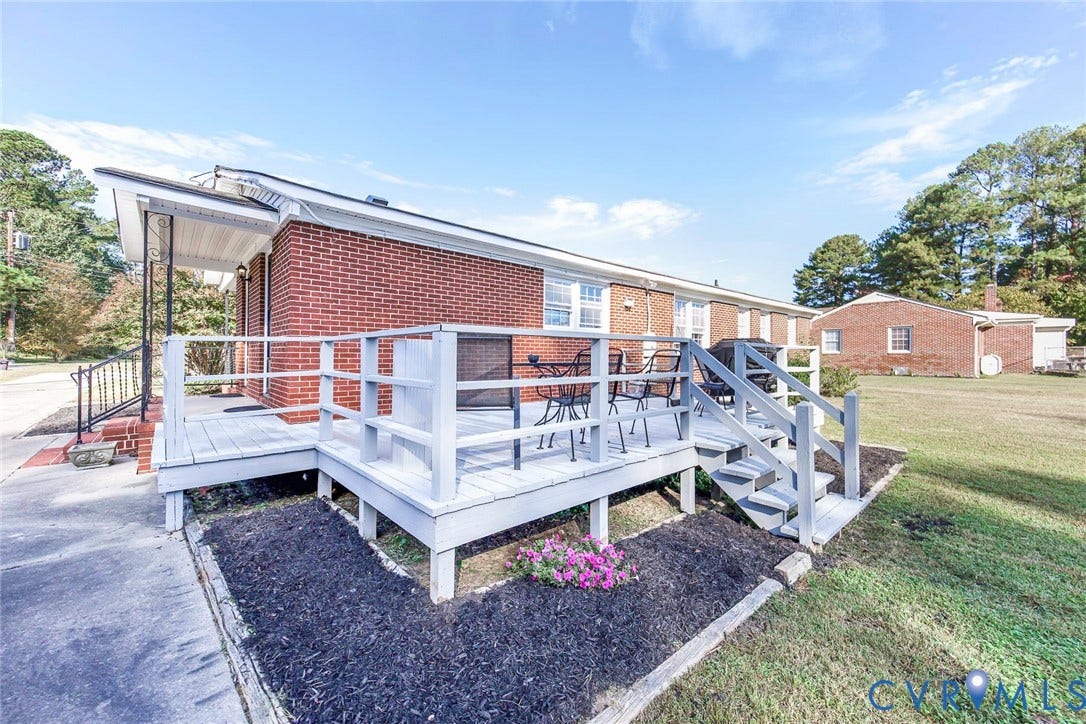 700 Lakeside Drive, Emporia, Emporia, VA 23847 Red brick exterior featuring a raised wood-deck platform, metal railings, and a concrete walkway
