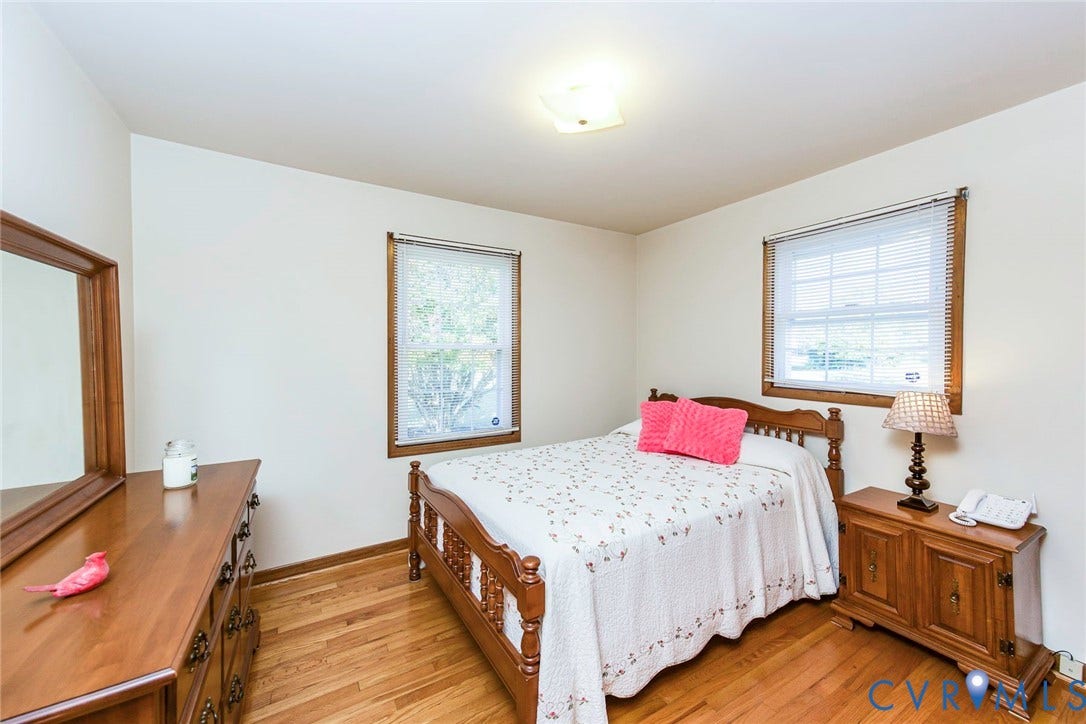 700 Lakeside Drive, Emporia, Emporia, VA 23847 Room featuring wood-finish flooring, two windows with wood-trimmed frames, and a flush-mount ceiling light fixture