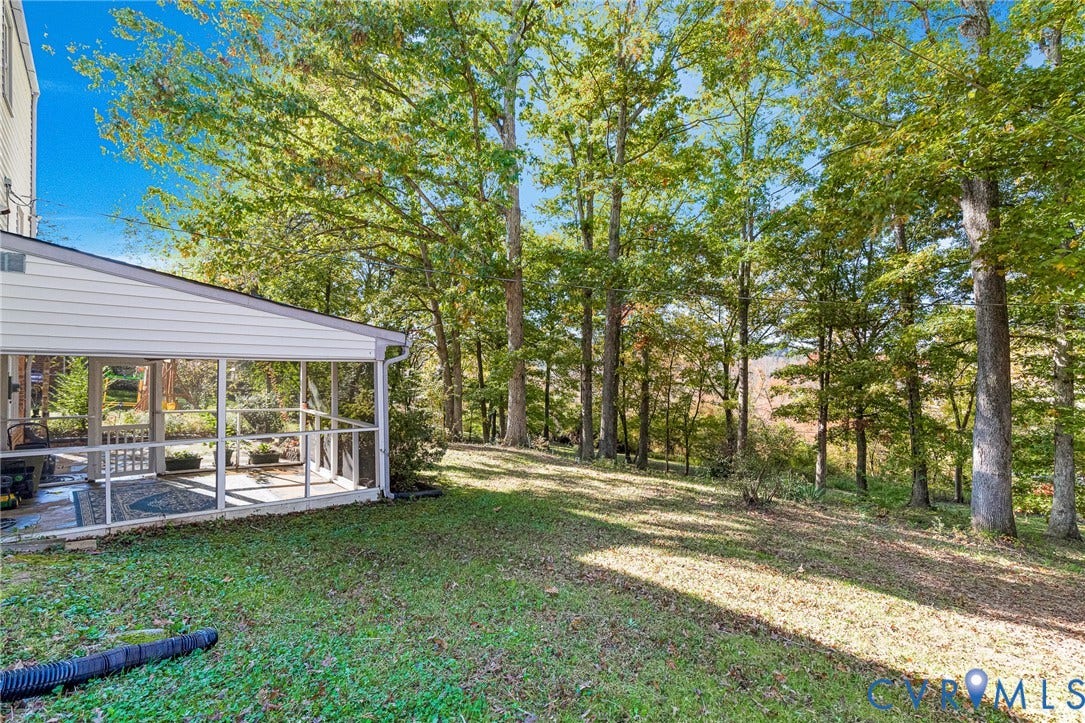 1526 Westshire Lane, Henrico, VA 23238 Screened-in porch featuring white structural framing, wood-finish flooring, and expansive natural surroundings with mature trees