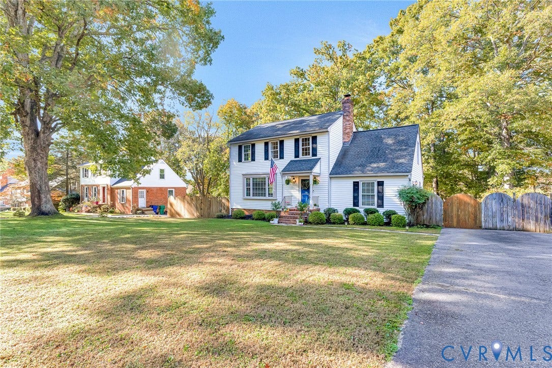 1526 Westshire Lane, Henrico, VA 23238 Two-story exterior featuring white horizontal siding, dark shutters, a brick chimney, shingled roof, and an asphalt driveway