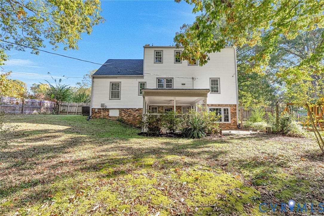 1526 Westshire Lane, Henrico, VA 23238 Multi-level exterior featuring white horizontal siding, a stone veneer foundation, a covered rear porch, and a fenced yard