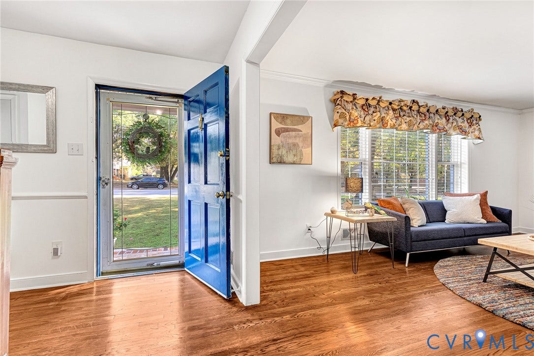 1526 Westshire Lane, Henrico, VA 23238 Entryway featuring wood-finish flooring, a six-panel exterior door, and wainscoting, including a window with crown molding