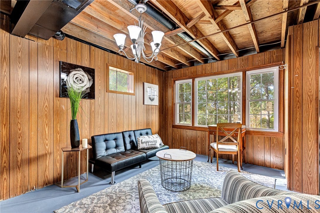 1526 Westshire Lane, Henrico, VA 23238 Wood-paneled walls, exposed ceiling joists, multi-light chandelier, and triple-pane window configuration