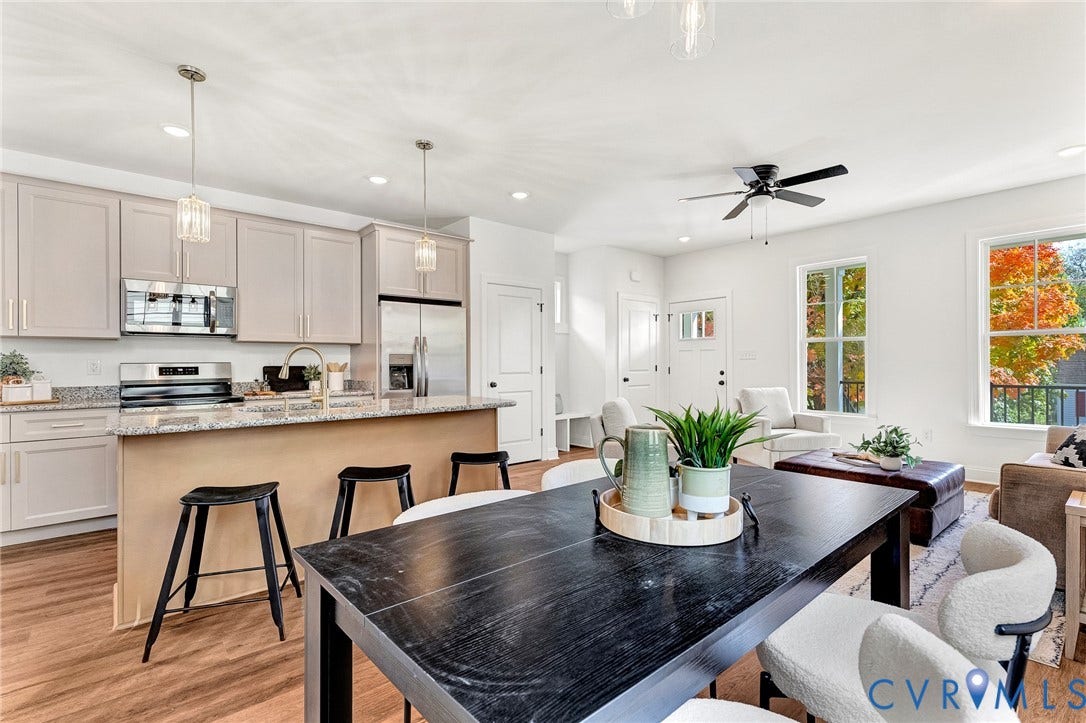 1807.5 Gordon Avenue, Oak Grove, Oak Grove, VA 23224 Kitchen featuring flat-panel cabinetry, stone countertops, a central island, stainless steel appliances, and wood-finish flooring