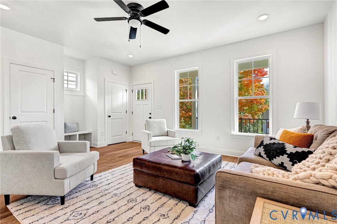 1807.5 Gordon Avenue, Oak Grove, Oak Grove, VA 23224 Living area featuring wood-finish flooring, two full-height windows, a ceiling fan, and built-in cabinetry