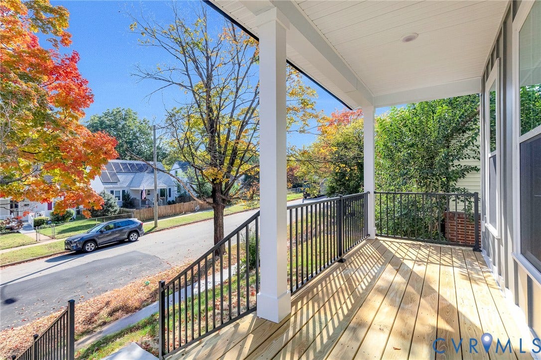 1807.5 Gordon Avenue, Oak Grove, Oak Grove, VA 23224 Covered front porch featuring wood decking, black metal railings, and square support columns with recessed ceiling lighting