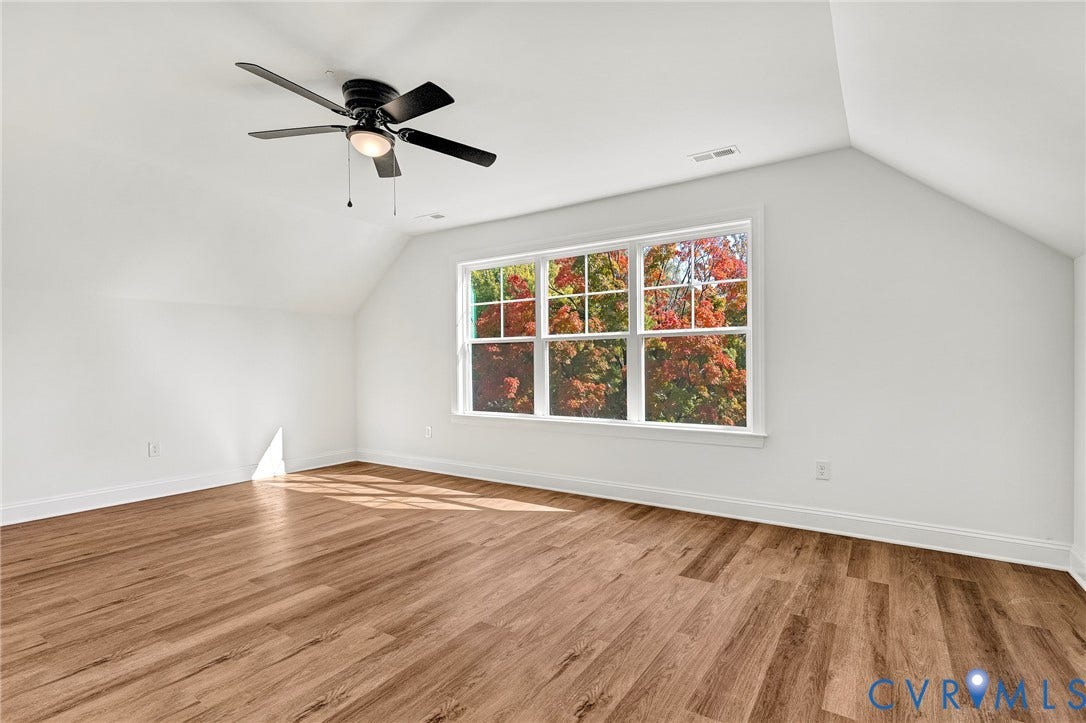 1807.5 Gordon Avenue, Oak Grove, Oak Grove, VA 23224 Vaulted ceiling with a matte black ceiling fan, wood-finish flooring, and large paneled windows