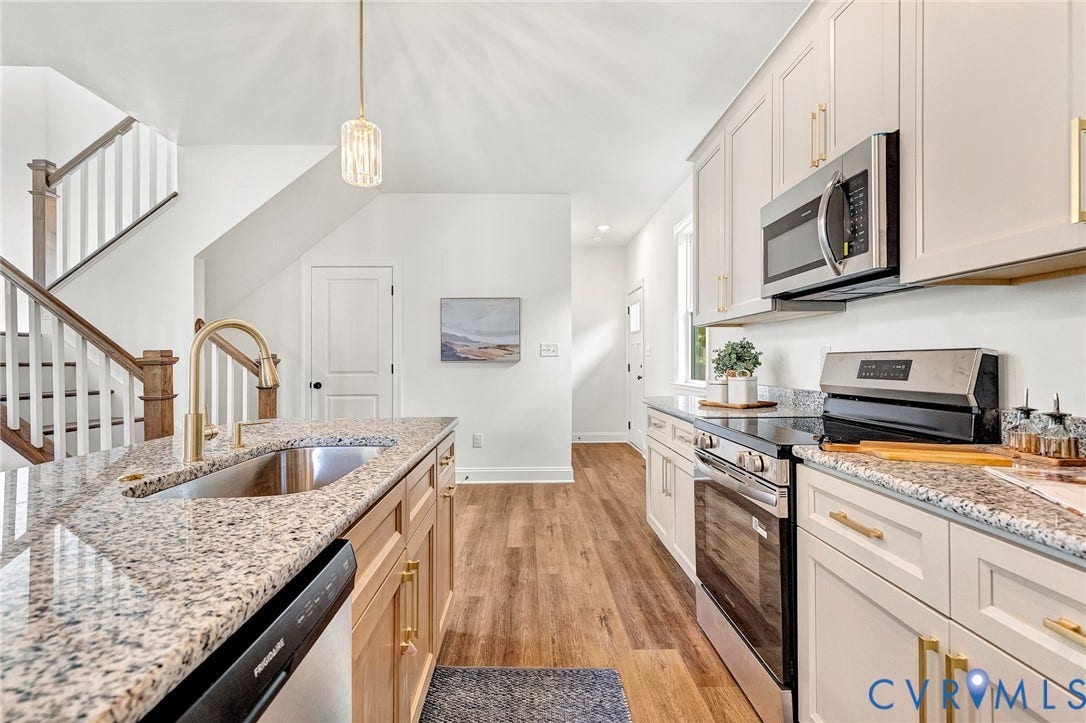 1807.5 Gordon Avenue, Oak Grove, Oak Grove, VA 23224 Kitchen featuring light-toned shaker cabinetry, stone-finish countertops, stainless steel appliances, a brass-finish faucet, and wood-finish flooring