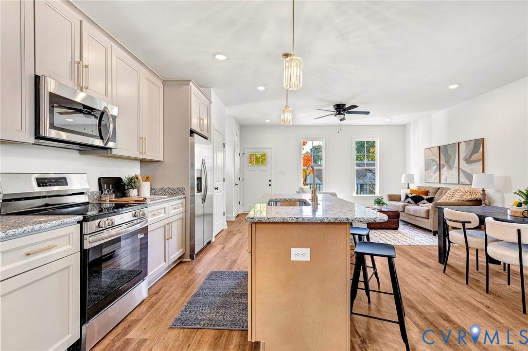 1807.5 Gordon Avenue, Oak Grove, Oak Grove, VA 23224 Kitchen featuring stone countertops, stainless steel appliances, a central island with bar seating, cabinetry with modern hardware, and wood-finish flooring