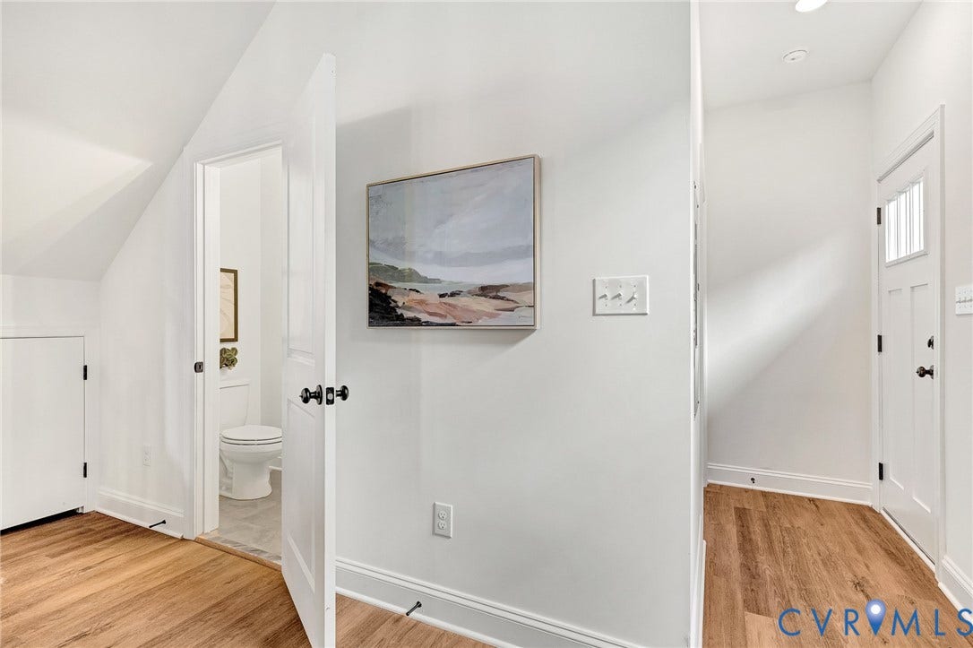 1807.5 Gordon Avenue, Oak Grove, Oak Grove, VA 23224 Wood-finish flooring, vaulted ceilings, and white interior doors featuring matte black hardware