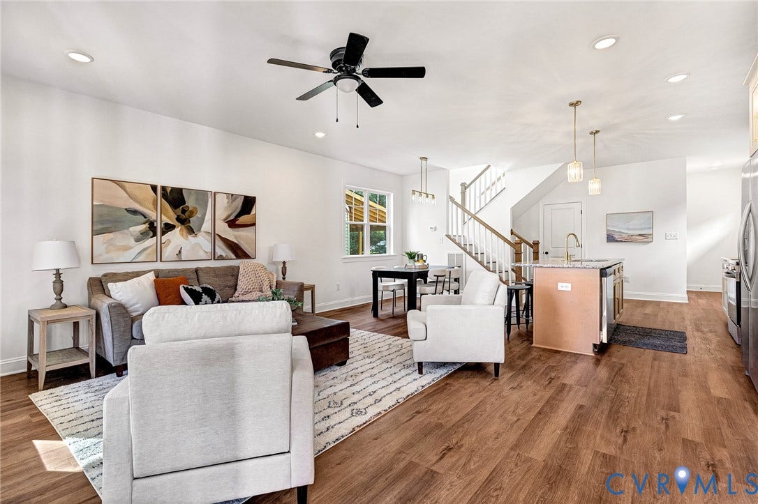 1807.5 Gordon Avenue, Oak Grove, Oak Grove, VA 23224 Open-concept interior featuring wood-finish flooring, recessed lighting, a ceiling fan, a kitchen island with a stone-finish countertop, and a staircase with a wooden handrail