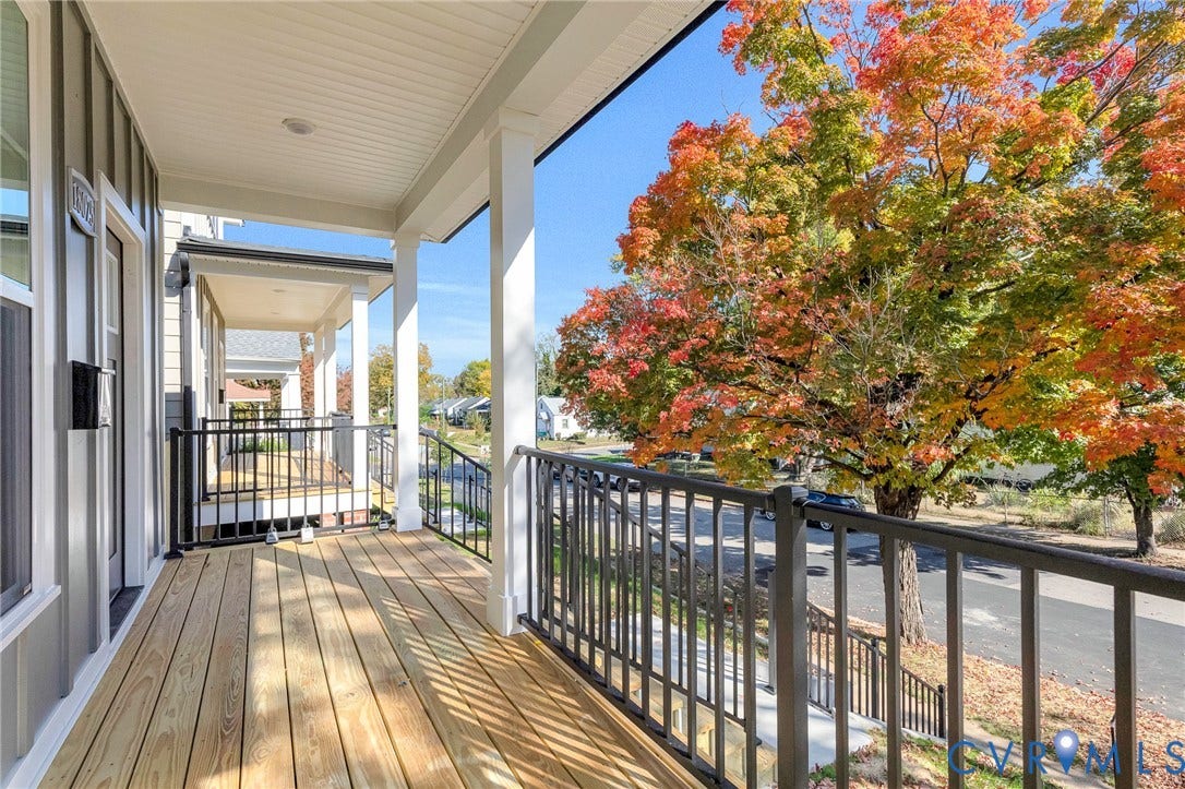 1807.5 Gordon Avenue, Oak Grove, Oak Grove, VA 23224 Covered front porch featuring wood-plank flooring, white structural columns, and black metal railings