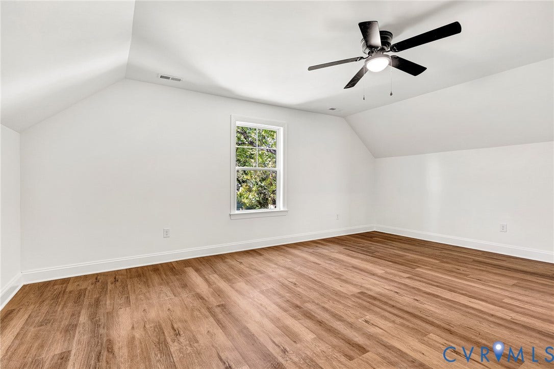 1807.5 Gordon Avenue, Oak Grove, Oak Grove, VA 23224 Sloped ceilings, wood-finish flooring, a single-hung window with a grille pattern, and an overhead ceiling fan with integrated lighting